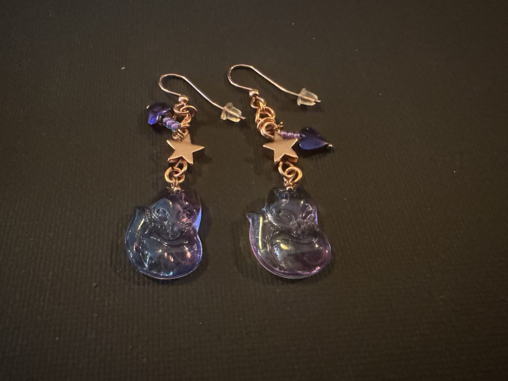 Fox charms with hematite hearts on copper wire.
